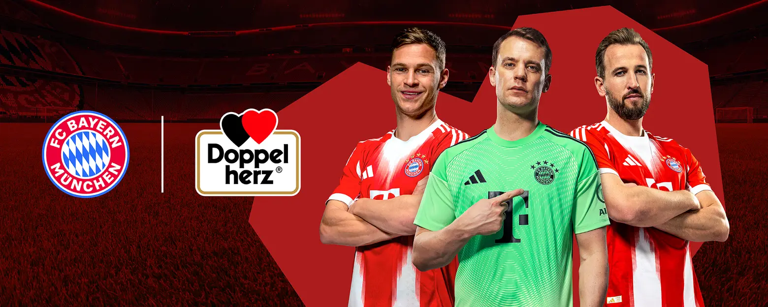 Three football players from FC Bayern Munich pose confidently in their team uniforms. The player on the left wears a red jersey, the middle player is in a green goalkeeper shirt, and the player on the right also wears a red jersey. The background displays the team's logo.
